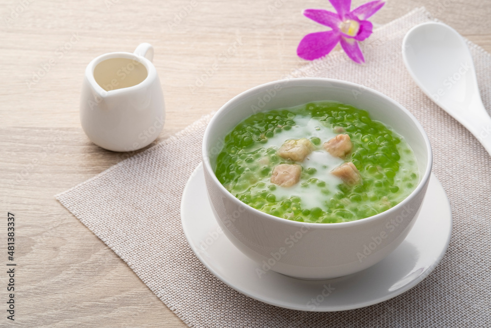 Pandan flavoured Tapioca pearl pudding with a dash of coconut milk,popular South-East Asian dessert in white bowl Pandan flavoured Tapioca pearl pudding with a dash of coconut milk,popular South-East Asian dessert in white bowl