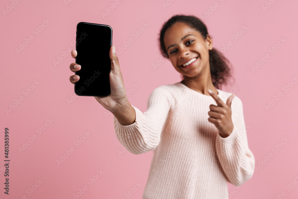 Black girl pointing finger and showing cellphone at camera Black girl pointing finger and showing cellphone at camera