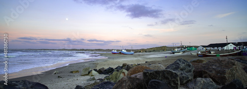 Beach of norre vorupor, denmark, sunset over old fishing boats photo