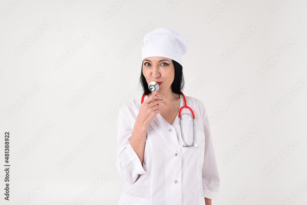 A female therapist with a stethoscope in the clinic on a white background A female therapist with a stethoscope in the clinic on a white background