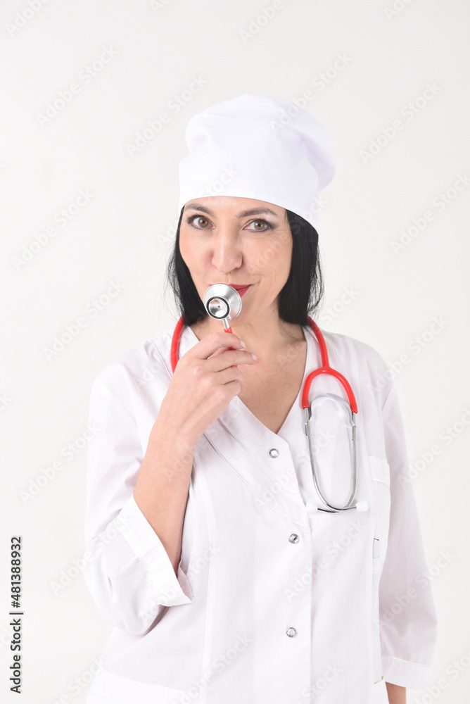 A female therapist with a stethoscope as if with a microphone in the clinic on a white background A female therapist with a stethoscope as if with a microphone in the clinic on a white background