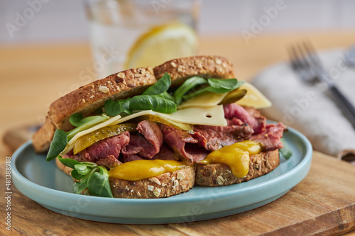 Delicious sandwich with egg and meat in toasted bread on plate