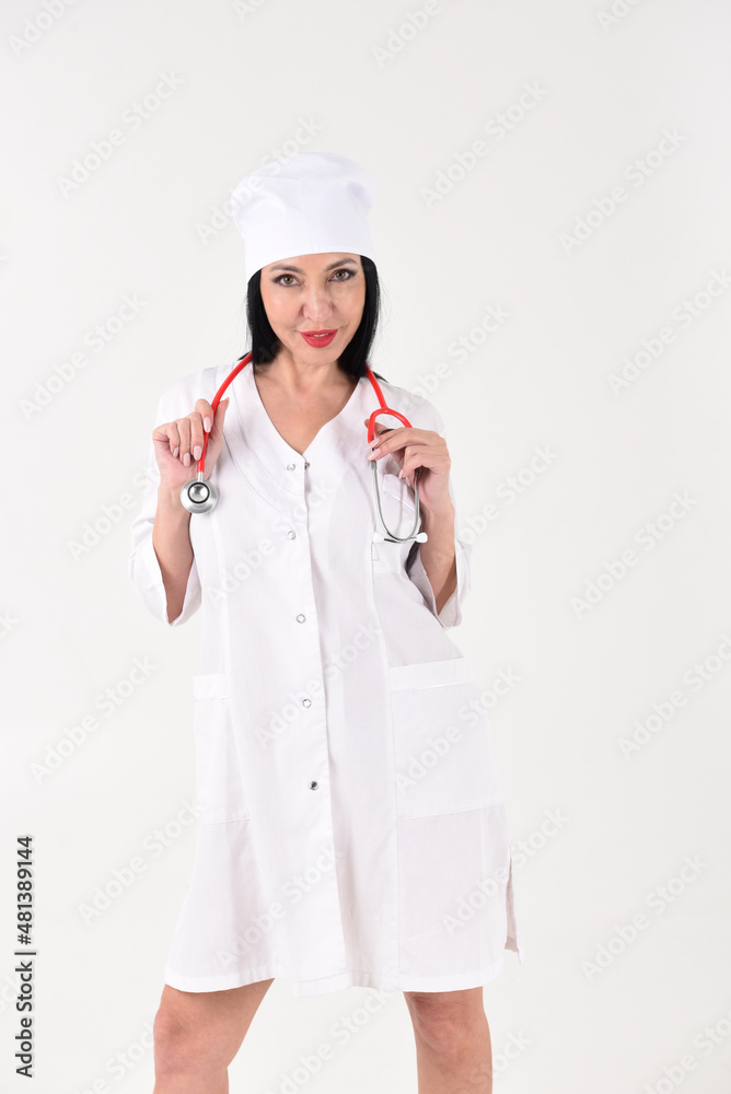 A female therapist with a stethoscope in the clinic on a white background