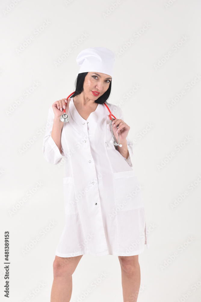 A female therapist with a stethoscope in the clinic on a white background A female therapist with a stethoscope in the clinic on a white background