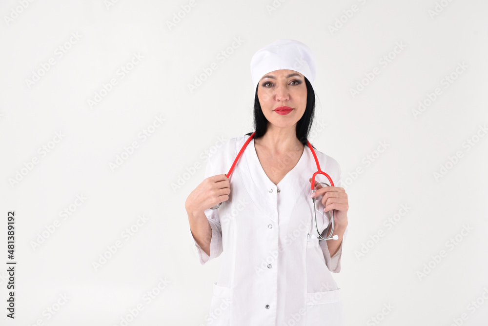 A female therapist with a stethoscope in the clinic on a white background A female therapist with a stethoscope in the clinic on a white background