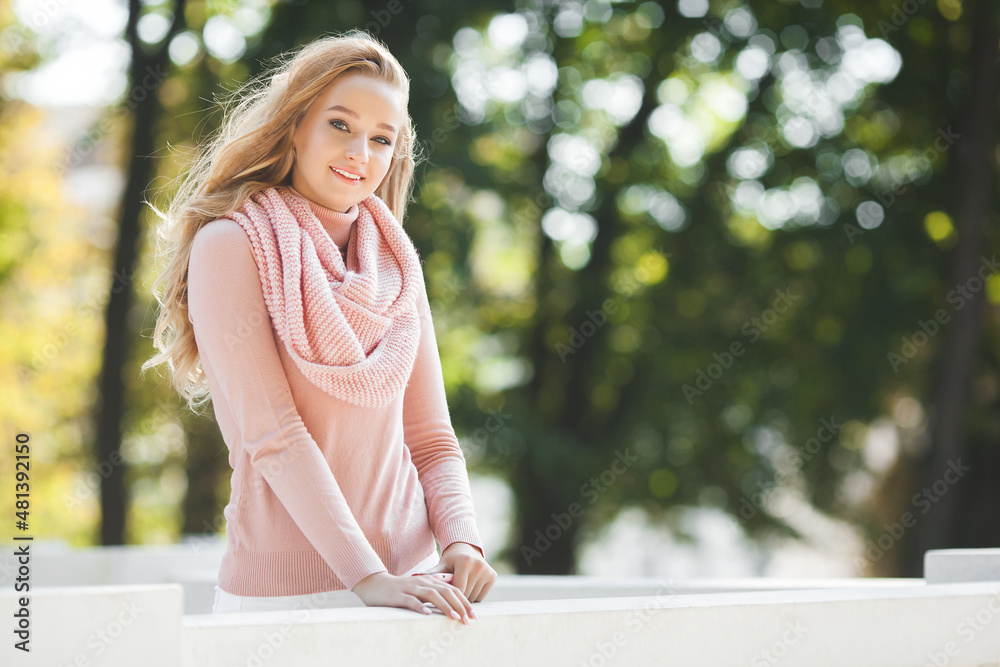 Attractive young woman closeup portrait. Blond female outdoors. Attractive young woman closeup portrait. Blond female outdoors.