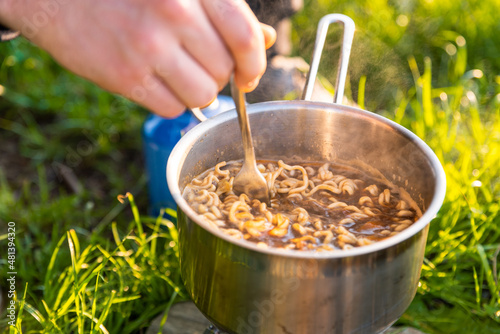 Camping food on gas stove. Ramen in camping stove