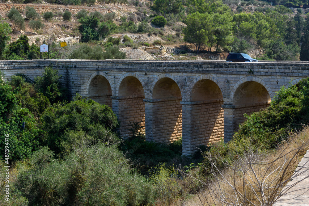 A Car crossing the Madliena Bridge over Wied Il-Faham (The Coal Valley) - Gharghur, Malta.