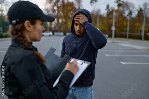 Upset man and police woman issuing fine