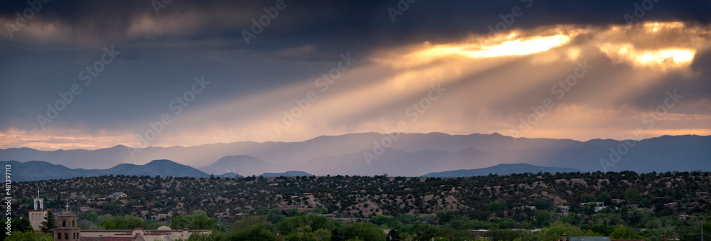 Naklejka premium This beautiful sunset landscape view in Santa Fe New Mexico ephasizes the layers of light in the mountaiins surrounding this city different.