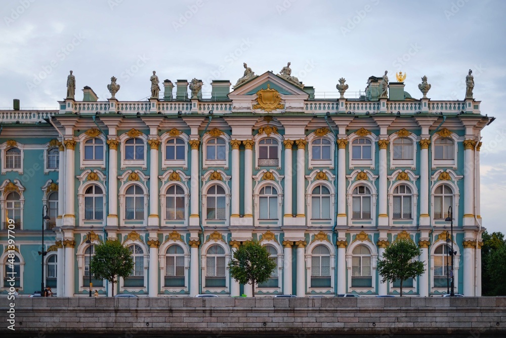 Windows and Statues adorning the Winter Palace from the side of the Dvortsovaya Embankment at sunset .