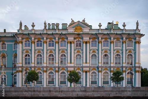 Windows and Statues adorning the Winter Palace from the side of the Dvortsovaya Embankment at sunset .