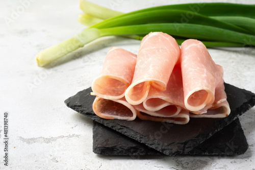 Sliced pork balyk. Dried pork, prosciutto. Prosciutto on a stone board