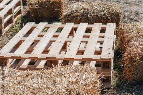 Seats made from wooden pallets and straw bales, placed for decoration at the festival. Selective focus. 