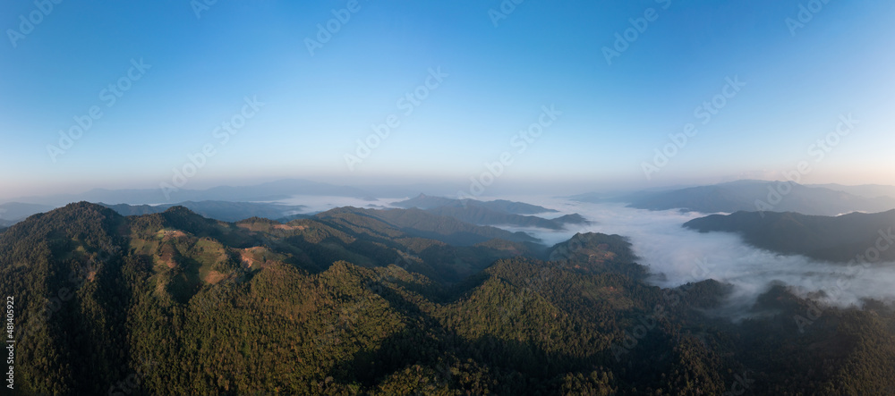 beautiful amazing landscape aerial view Mountain fog in the valley at morning with blue sky background