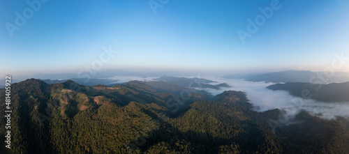 beautiful amazing landscape aerial view Mountain fog in the valley at morning with blue sky background © SHUTTER DIN