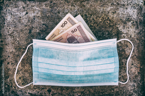 Surgical medical face mask and  bosnian convertible mark) paper money.
 photo