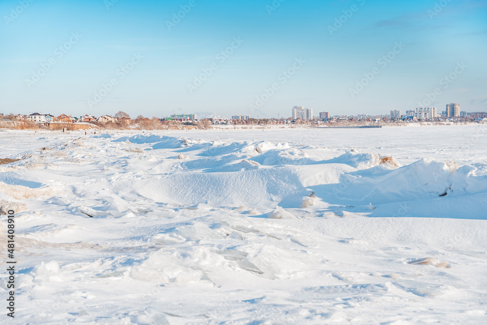 Chunks of ice on a frozen river on a sunny winter day