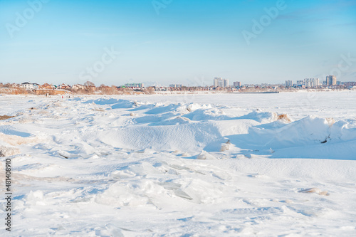 Chunks of ice on a frozen river on a sunny winter day © KseniaJoyg