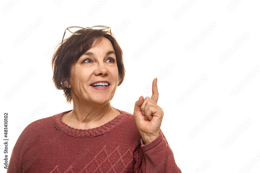 Portrait of attractive cheerful intelligent mature woman pointing forefinger up isolated over white color background Portrait of attractive cheerful intelligent mature woman pointing forefinger up isolated over white color background