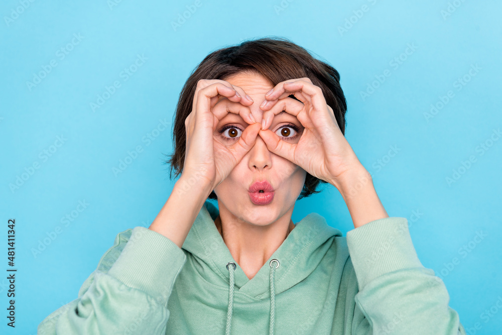 Photo of funky funny lady dressed green pullover showing arms spectacles cover eyes isolated blue color background Photo of funky funny lady dressed green pullover showing arms spectacles cover eyes isolated blue color background