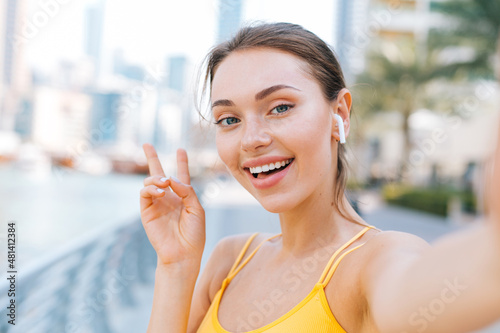 Free Download Young beautiful woman take a selfie picture on her smartphone - GFXLoad