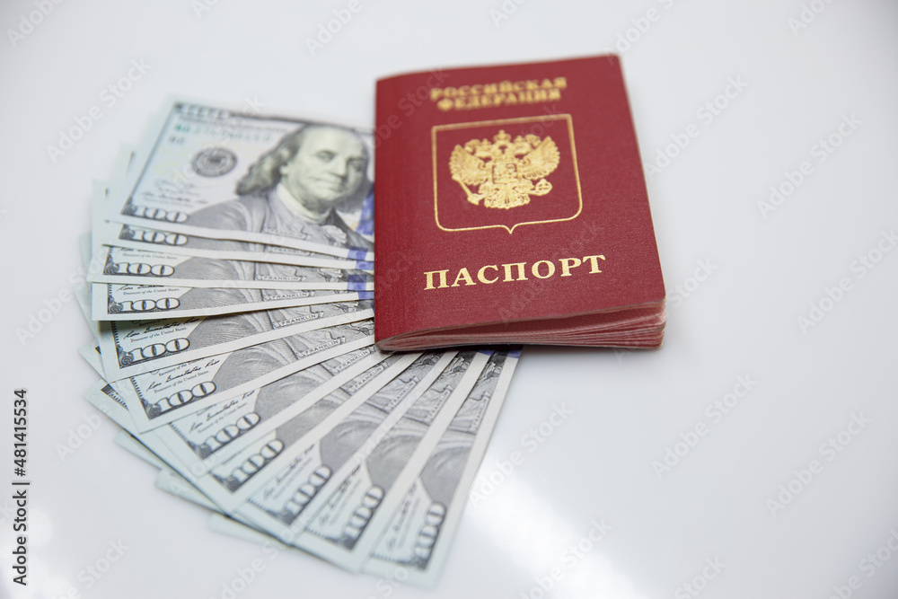 Russian passport and one hundred dollar bills Russian passport and one hundred dollar bills