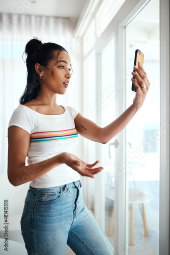 Always building relevant content. Cropped shot of an attractive young blogger standing in her home and using her cellphone to record a vlog. Free Download Always building relevant content. Cropped shot of an attractive young blogger standing in her home and using her cellphone to record a vlog. - GFXLoad