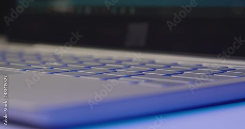 The girl connects the cable to the laptop. Close-up.