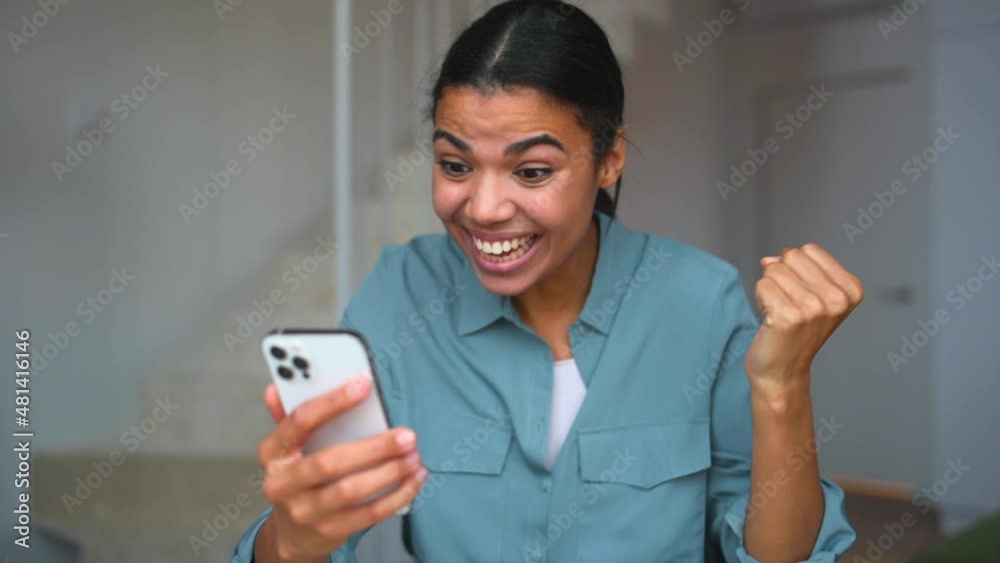 Surprised woman looking at the phone screen sitting at the deskat home. Wondered young lady saw unexpected good news or received pleasantly message, sales proposal on the smartphone Surprised woman looking at the phone screen sitting at the deskat home. Wondered young lady saw unexpected good news or received pleasantly message, sales proposal on the smartphone