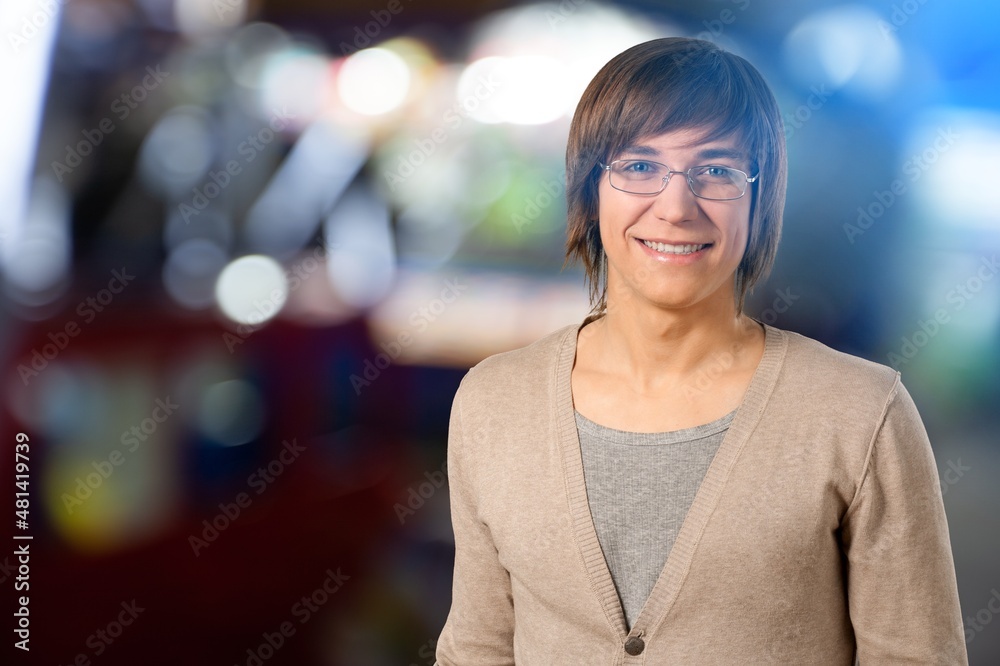 Fototapeta premium Portrait of Handsome Man Smiling, Looking at Camera, Standing in Night City with Bokeh