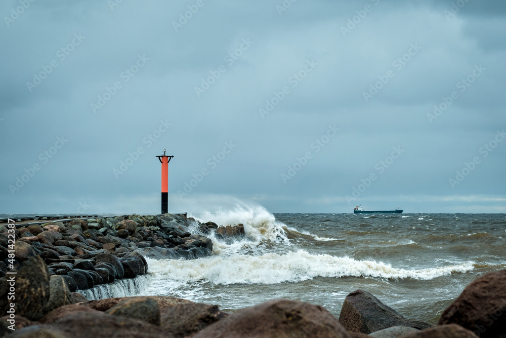 lighthouse by the sea on a windy cloudy day