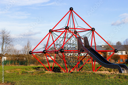 a slide with a climbing net in the playground next to the school in Heywood England
