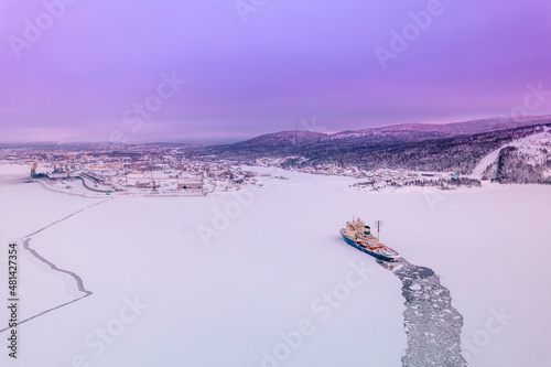 Icebreaking vessel in Arctic with background of sunset