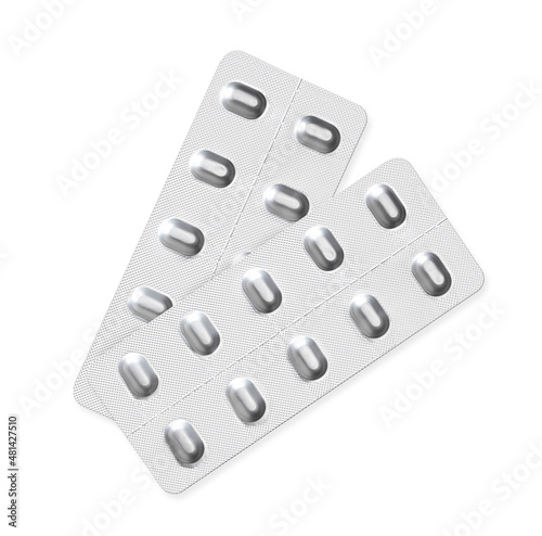 Isolated tablet pills in blister package or pill pack. Two silver aluminum 10-pack pill dispenser used for drugs, medication and vitamins.
