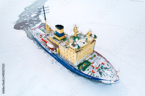 Icebreaking vessel in Arctic with background of sunset