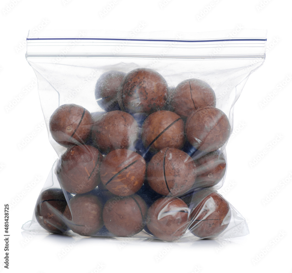Obraz premium Macadamia nuts in pack on white background isolation