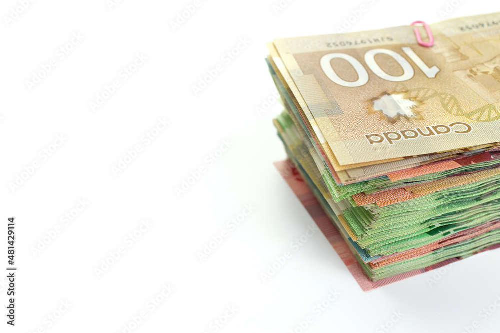 High Angle View of Large Stack of Canadian Banknotes on a White Background High Angle View of Large Stack of Canadian Banknotes on a White Background