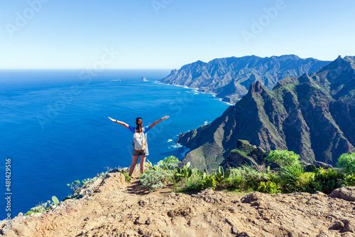 Woman hiker watching beautiful costal scenery. - Tenerife, Canary Islands, Spain. coast view, mountain Anaga photo