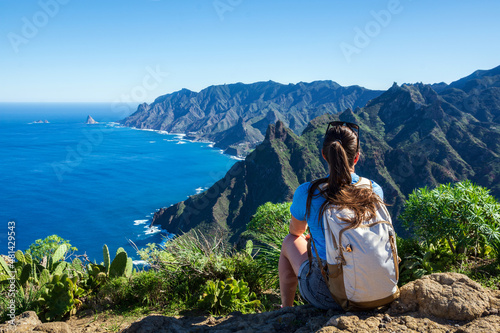 Woman hiker watching beautiful costal scenery. - Tenerife, Canary Islands, Spain. coast view, mountain Anaga photo