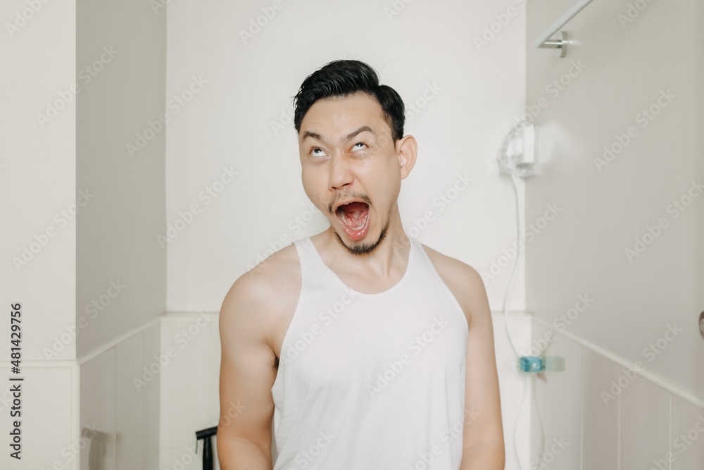 Funny face expression of Asian man try to poop in the toilet. Funny face expression of Asian man try to poop in the toilet.