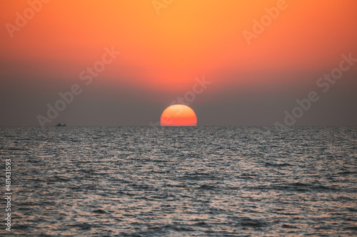 Fototapeta Naklejka Na Ścianę i Meble -  Sundown Above Sea Horizon At Sunset. Natural Sunrise Sky Warm Colors Over Ocean