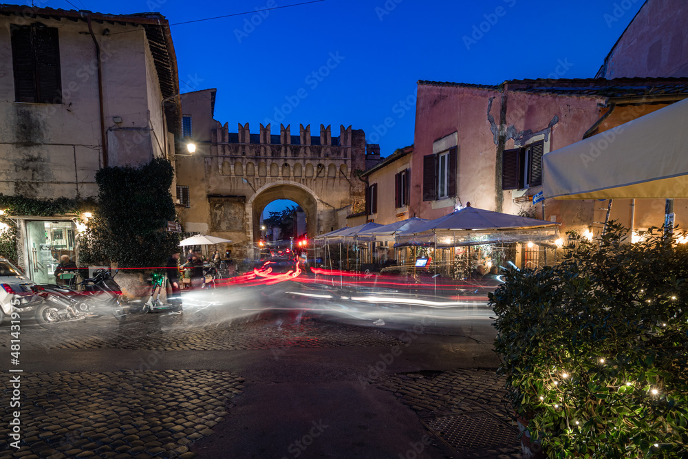Trastevere Rome Italy at night. View of an Italian scooter motorcycle on the street corner Trastevere Rome Italy at night. View of an Italian scooter motorcycle on the street corner