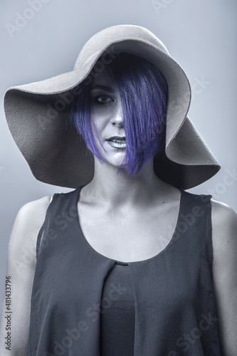 Portrait of a young woman with purple hair, studio shot