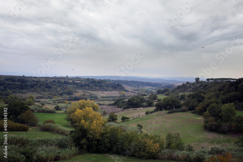The rural green landscape of the Marta Valley, with the backdrop of the Cimini Mountains and the Tolfa, from the terrace of the belvedere, Tuscania, Tuscia, Lazio, Italy
