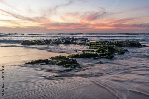 Sunset at low tide in the Atlantic Ocean. Vila Nova de Milfontes photo