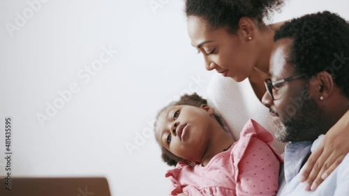 Confident African parents talking something to their daughter at home