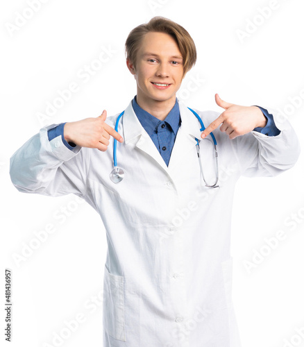 portrait of a student, teenager, young professional. a guy in a medical gown looks at us and points to himself. place for an inscription or product.