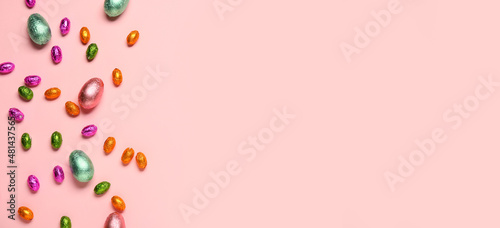 Sweet chocolate Easter eggs on color background with space for text