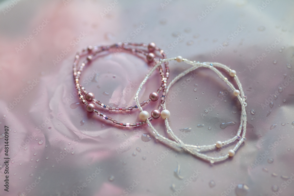 Beaded bracelets on a background of roses, handmade Beaded bracelets on a background of roses, handmade